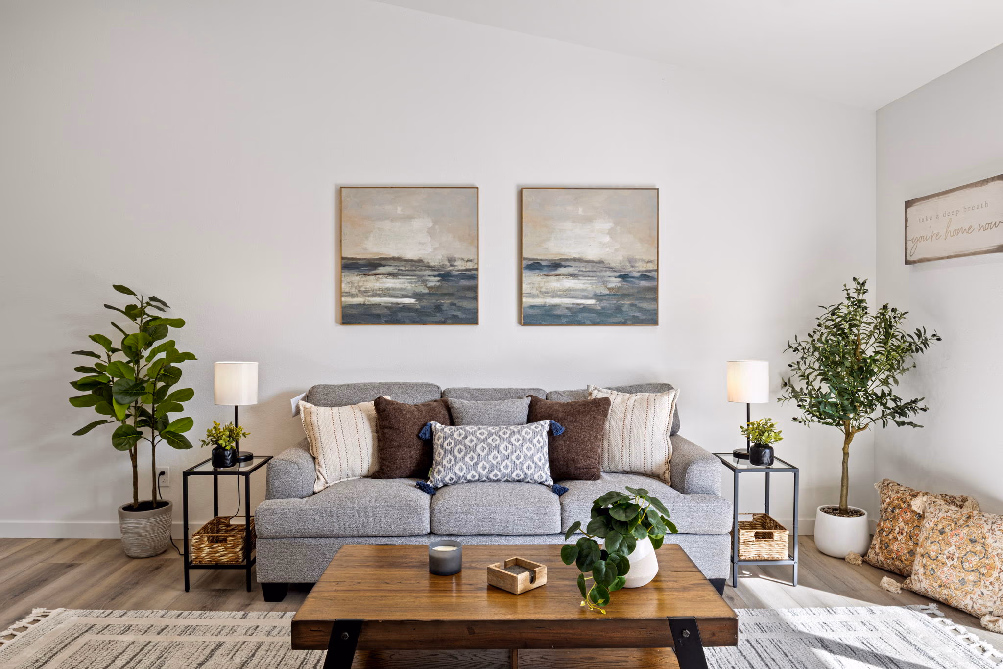 Modern living room with neutral decor, grey sofa, and natural light — Roseburg Oregon home on Fir Grove Lane